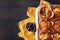 A group of mafins with berries and chocolate on a dark wooden background. FLat lay.