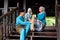 A group of malay muslim people in traditional costume having happy conversation during Aidilfitri celebration at terrace of