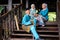 A group of malay muslim people in traditional costume having happy conversation during Aidilfitri celebration at terrace of