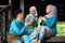 A group of malay muslim people in traditional costume showing greeting gesture during Aidilfitri celebration at terrace of