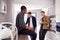 Group Of Male College Students In Shared House With Hot Drinks In Kitchen Hanging Out Together