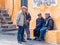 Group of male elderly Sardinian villages talking on the street