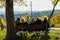 Group of Male and Female Seniors Sitting on Bench with View in Autumn