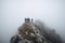 A group of male hikers with backpacks climb a rocky hill.