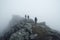 A group of male hikers with backpacks climb a rocky hill.