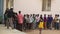 A group of male students waiting to practice Yoga at school auditorium