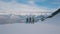 Group of male tourist active backpack wearing sport equipment standing on peak of rock aerial shot