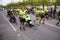 Group of marathon runners pushing running wheel chairs with disabled persons helping them fulfill the run.