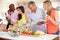 Group Of Mature Friends Enjoying Buffet At Dinner Party