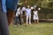 Group Of Mature Friends Playing Croquet In Backyard Together