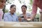 Group of mature people playing Chinese checkers