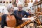 Group of mature violin maker in pose