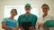 Group of medical professionals, mature man and two young women. Close portrait of doctors in the office of the clinic