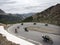 Group of men on motorcycle reaches col d`izoard in the french haute provence alps