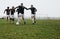 Group of men playing soccer on the field