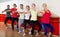 Group of men and women practicing at the ballet barre