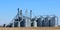 Group of metal grain storage bins on a sunny day