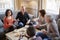 Group Of Middle Aged Friends Meeting Around Table In Coffee Shop