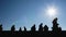 Group of middle school students running against sky background, sunny day Europe