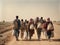 A group of migrants with children walk along a dusty road.