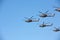 Group Military helicopters against the blue sky.