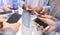 Group of millennials using cellphones, standing in circle