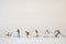 Group of miniature figures of skiers on a white background