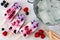 Group of mixed berry yogurt popsicles on white marble