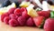 Group of mixed fresh berries and cubes of coconut