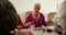 Group of Mixed-race senior friends eating breakfast on dining table 4k