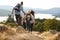 A group of mixed race young adult friends descending after a mountain hike, back view