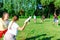 Group of mixed young teenagers people in casual wear playing with flying plastic disk game in a park oudoors. men and women tosses