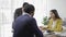 Group of modern Asian young businessmen in suits are brainstorming while sitting in a business meeting.