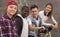 Group of modern teenagers posing and smiling in yard