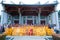 A Group of monks and administrators sitting together in the line up in front of the Chinese monastery