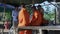 Group of monks sitting on bamboo slats