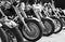 Group motorbikes parked together on outdoors.