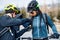 Group of mountain bikers standing on road outdoors in winter.