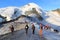 Group of mountaineers with crampons on ski slope ascending towards mountain Allalinhorn and snow mountain panorama in Pennine Alps