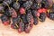 Group of mulberries isolated on wood.