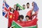 Group of multi-ethnic friends holding various national flags against white background