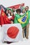 Group of multi-ethnic friends holding various national flags against white background