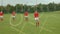 Group of multi ethnic rugby players playing football on football field.