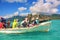 Group of multi-racial people on old tourist sightseeing boat watching famous Crystal Rock,Mauritius