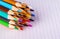 Group of multicolor pencils on white checkbook