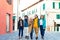 Group of multicultural young people walking outdoor in line during coronavirus time on a city street background.City outbreak