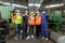 Group of multiethnic engineer with workers giving thumbs up and wearing surgical mask to prevent covid-19 in manufacturing factory