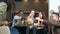 Group of multiethnic happy friends playing block removal game and laughing and rejoicing at a bowl of popcorn having fun together