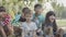 Group of multiethnic kids sitting together on open air lesson