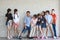 Group of multiethnic school kids playing together in line in classroom with happy smiling face on white wall background education